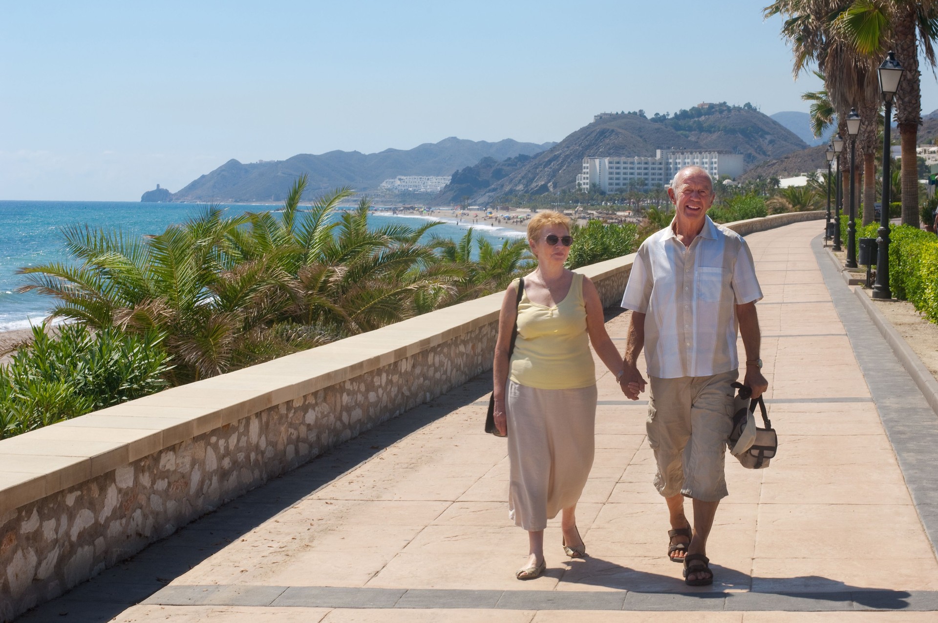 senior couple walking on holiday or are they expatriates